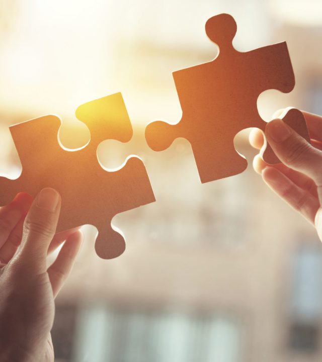 Businesswoman hand connecting jigsaw puzzle, Business solutions, success and strategy concept